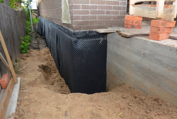 SJ Waterproofing Pros technician performing targeted Wet Basement Repair assessment in Sevierville, TN